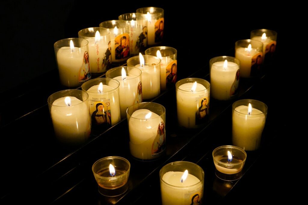 a group of lit candles sitting on top of a table